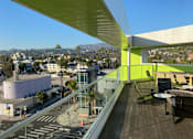 Thumbnail 14 of 18 - Fusion Hollywood Apartments view of Hollywood Los Angeles from a rooftop with a green wall.