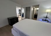 Thumbnail 28 of 60 - Fusion Orlando furnished apartments Orlando. 1-bedroom with a large bed and a black dresser.