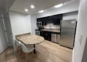Thumbnail 27 of 60 - Fusion Orlando furnished apartments Orlando kitchen with a granite countertop and stainless steel appliances.