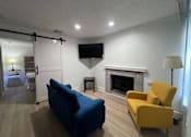 Thumbnail 26 of 60 - Fusion Orlando Apartments living room with a blue couch and yellow chair.