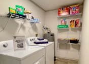 Thumbnail 18 of 49 - Walk-in pantry in the Retreat at Indian Lake one bedroom apartments in Hendersonville with built in wire shelving and in-unit laundry.