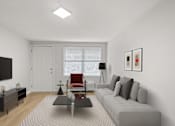Thumbnail 1 of 36 - Retreat at Indian Lake apartments in Hendersonville, TN living room with a grey sofa, a red chair, a black table, and a white door.
