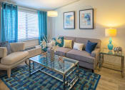 Thumbnail 9 of 49 - Living room in the Retreat apts at Indian Lake in Hendersonville with large window, air conditioning unit, and modern decor.