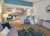 Thumbnail 7 of 49 - Open Concept living room and kitchen in the Retreat apts at Indian Lake in Hendersonville with modern glass coffee and console tables.