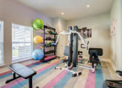 Thumbnail 15 of 23 - Mandarin Bay Apartments Fitness Center with cardio equipment, and exercise balls, and striped flooring