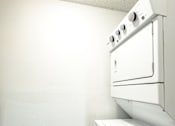 Thumbnail 13 of 38 - An in-unit white washer and dryer in a small room at Mandarin Bay Apartments.