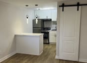 Thumbnail 19 of 49 - The Retreat at Indian Lake - studio kitchen with an island and a stove and a refrigerator