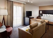 Thumbnail 2 of 18 - A furnished apartment at Fusion Buckhead with a bed, couch, and television.