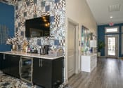 Thumbnail 36 of 49 - The Retreat apartments at Indian Lake lobby coffee bar with self-serve coffee supplies, black modern cabinets, and mini fridge.
