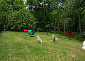 Thumbnail 33 of 36 - A pet park with a green slide and a red slide at The Retreat at Indian Lakes Apartments in Hendersonville TN.