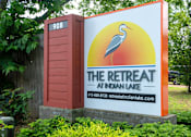 Thumbnail 22 of 36 - Monument sign for The Retreat at Indian Lake Apartments with a crane on it.