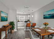 Thumbnail 1 of 38 - A dining room with a wooden table set for four at Mandarin Bay Apartments.