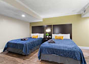 Thumbnail 7 of 41 - Two beds with blue bedspreads in a bedroom at Fusion Orlando.
