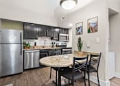 Thumbnail 4 of 41 - A kitchen with a table and chairs at Fusion Orlando Furnished Apartments.
