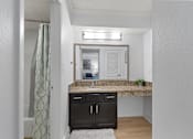 Thumbnail 16 of 41 - A bathroom with a sink and a mirror.