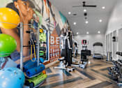 Thumbnail 22 of 41 - Fusion Orlando fitness center with a variety of equipment and a motivational poster on the wall.