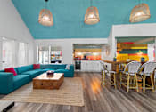 Thumbnail 26 of 41 - Fusion Orlando clubhouse with a blue couch and a wooden coffee table.