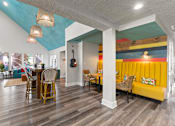 Thumbnail 28 of 41 - A room with a wooden floor and a yellow couch at the Fusion Orlando clubhouse