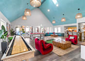 Thumbnail 24 of 41 - Fusion Orlando apartments clubhouse with a pool table and a red chair.
