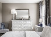 Thumbnail 11 of 19 - a bedroom with a large white dresser with a mirror on top of it