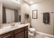 Thumbnail 12 of 19 - a bathroom with a toilet sink mirror and shower