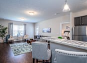 Thumbnail 9 of 55 - Arbors at Turnberry pet friendly apartments and townhomes Pickerington, Ohio wood style flooring, stainless steel appliances, spacious living room with a kitchen and dining area