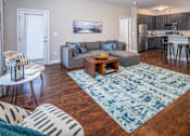Thumbnail 11 of 55 - Arbors at Turnberry pet friendly apartments and townhomes Pickerington, Ohio spacious living room with wood style flooring and natural light. Balcony and private attached garage.