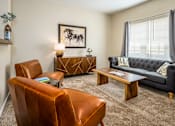 Thumbnail 26 of 55 - Pickerington, OH Apartments - Arbors at Turnberry - Furnished Living Room with Carpet Flooring, Window, Sofa, Leather Chairs, Coffee Table, and Side Table