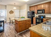Thumbnail 22 of 55 - Arbors at Turnberry Apartments Pickerington Ohio Pet Friendly Updated Modern Kitchen wood style flooring, stone style countertops, kitchen island