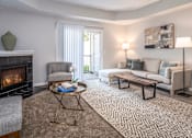 Thumbnail 20 of 55 - Arbors at Turnberry Apartments Pickerington Ohio Pet Friendly Updated Modern Interior spacious living room with carpet flooring, fireplace, natural light