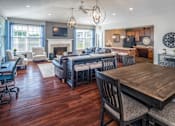 Thumbnail 5 of 55 - a living room and dining room with hardwood floors and a fireplace
