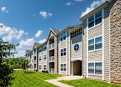 Thumbnail 1 of 55 - Apartments for Rent in Pickerington, OH - Arbors at Turnberry - Apartment Building Exterior with Lush Landscaping