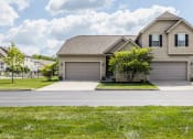 Thumbnail 10 of 19 - a house with a two car garage