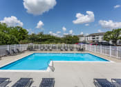 Thumbnail 26 of 29 - Indianapolis, IN Apartments - Riverchase - Sparkling Pool With Sundeck, Lounge Chairs, Tables With Umbrellas, And Apartment Homes In The Background