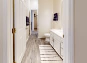 Thumbnail 9 of 29 - a bathroom with a white sink and toilet and a rug on the floor