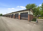 Thumbnail 7 of 25 - Studio apartments at Austin Park in Miamisburg, OH provide detached single-car parking garages accessible via an alleyway, surrounded by maintained landscaping.