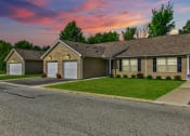 Thumbnail 13 of 16 - a home with a gray roof and a pink and purple sky in the background