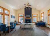 Thumbnail 18 of 27 - a living room with a fireplace and a table and chairs