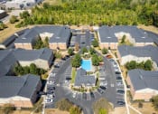 Thumbnail 27 of 27 - an aerial view of a neighborhood with houses and a swimming pool