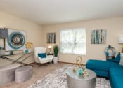 Thumbnail 5 of 27 - a living room with a blue couch and white chair