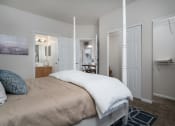 Thumbnail 7 of 21 - Two-bedroom apartment at Catalina Club in Pataskala, OH, showcasing a carpeted bedroom with ample closet space and an en-suite bathroom.