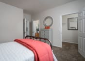 Thumbnail 10 of 21 - Simple, well-lit bedroom at Catalina Club Apartments in Pataskala, OH, with neutral decor and carpeted flooring.