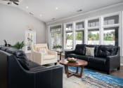 Thumbnail 14 of 21 - Living room at Catalina Club filled with contemporary furniture and a large window for natural lighting.