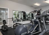Thumbnail 16 of 21 - Fully equipped fitness center at Catalina Club Apartments, offering a wide range of exercise machines and workout space.