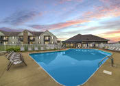 Thumbnail 4 of 21 - Resort-style swimming pool at Catalina Club Apartments in Pataskala, OH, complete with a spacious sundeck and lounge chairs.