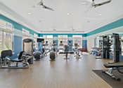 Thumbnail 14 of 25 - A yoga room and a fitness center equipped with free weights and cardio machines are available as an amenity.