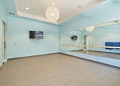 Thumbnail 16 of 25 - A yoga room and fitness center with free weights are available as an amenity.