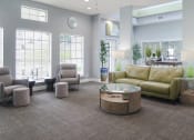 Thumbnail 13 of 19 - Furnished living room filled with cozy furniture and natural light from a large window