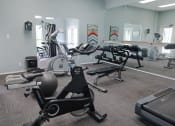 Thumbnail 14 of 19 - Fully equipped fitness center at The Boulevard in Florence, KY with free weights, bench press, and mirrored walls
