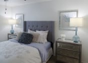 Thumbnail 4 of 19 - Stylish bedroom with plush carpet, ceiling fan, and vaulted ceiling in a one-bedroom apartment at The Boulevard